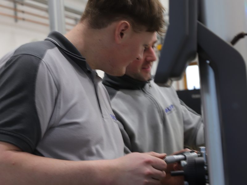 Mitarbeiter bei der Qualitätskontrolle von Drehteilen bei Bauer Zerspanungstechnik